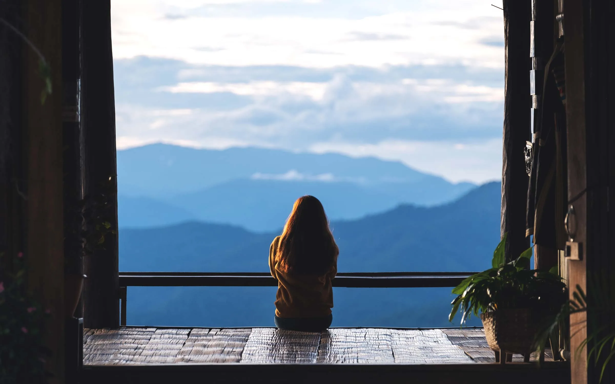 a-female-traveler-sitting-and-looking-at-a-beautif-2022-12-16-05-13-36-utc.jpg